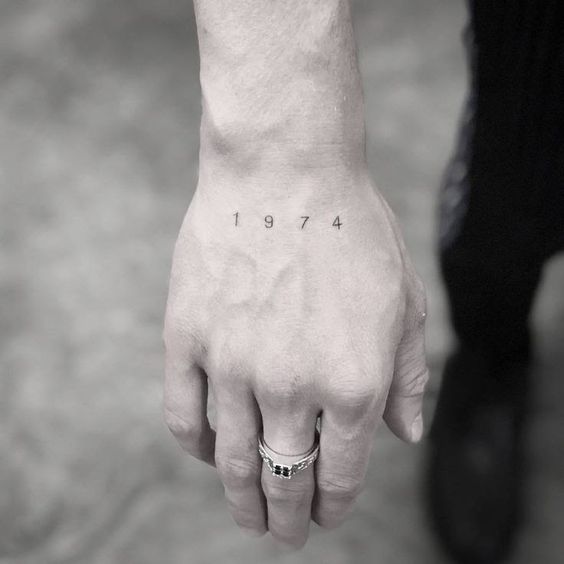 Simple Black Ink Year Tattoo on Hand